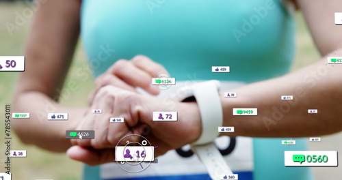 Image of notification bars over midsection of female marathon runner checking smartwatch