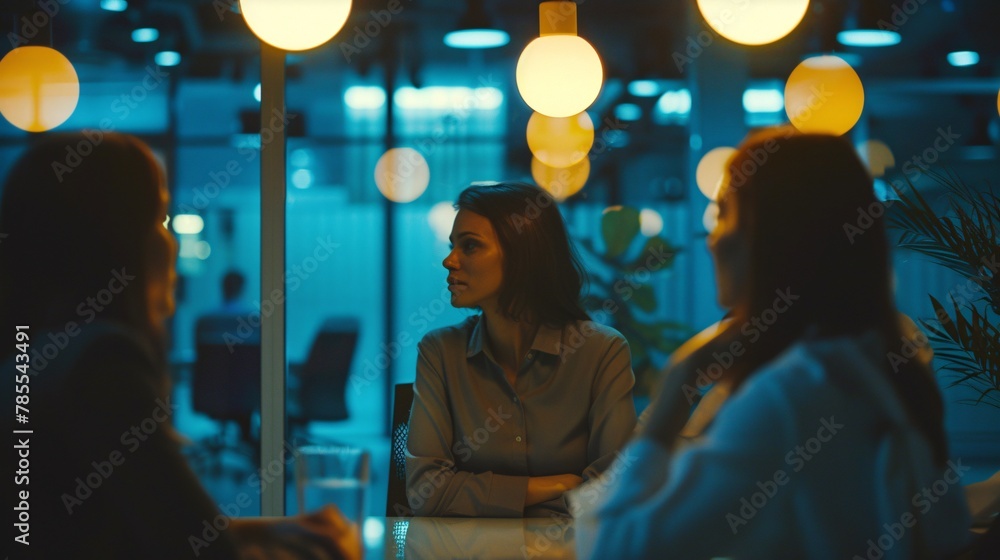 Women in discussion during a business meeting in a bright office Women in discussion during a business meeting in a bright office
