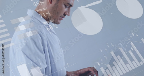 Image of medical data processing over attractive male medical worker wearing white suit using laptop