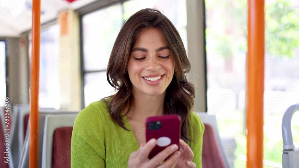 Happy Mexican woman having fun online while riding in a bus Happy Mexican woman having fun online while riding in a bus