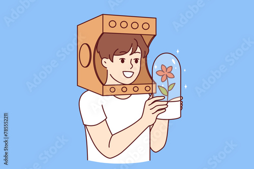 Child in paper astronaut helmet dreams of flying into space on shuttle, holding flask with plant in hands. Boy astronaut fantasizing about research mission to other planets to grow flowers photo