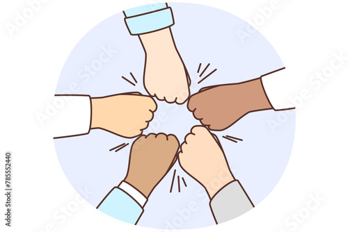 Diverse people give team fists bump