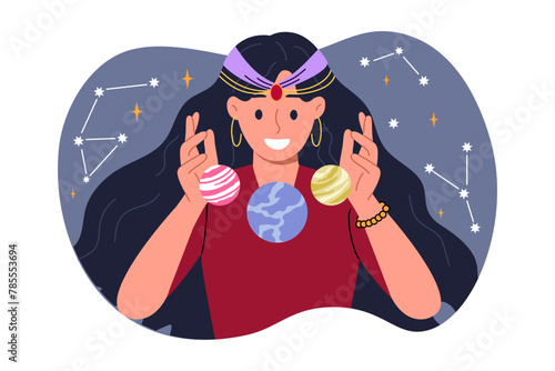 Woman fortune teller is interested in astrology, predicting future by studying constellations in sky and positions planets. Girl studies astrology and numerology, compiling horoscopes or natal chart.