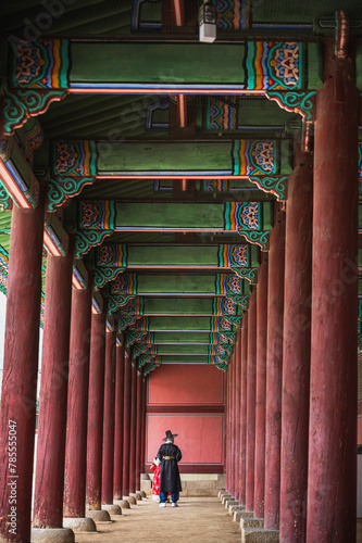 Vertical back view man in Hanbok traditional Korean costume walking in historical Gyeongbokgung Palace in Seoul, South Korea © Jack Tamrong