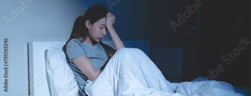 Sad worried and stressed, depressed asian young woman, girl suffering in bed from insomnia problem, awake at night, hand covering face from trouble disturbed loud noise, unable sleep. Restless people.