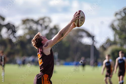 an australian rules football player catching the ball © AlazySM
