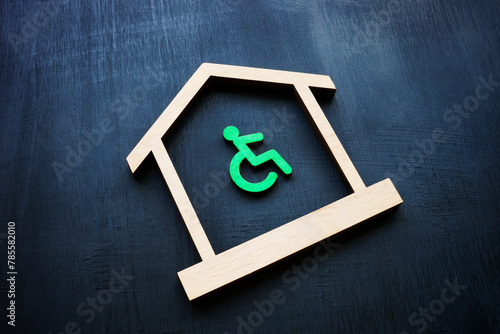 Disabled Person sign and house as symbol of real estate. Accessible home ownership rights.