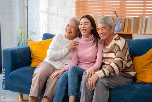 Generational Bonding: Cheerful Young Woman Embraces Elderly Parents at Cozy Home, Radiating Happiness and Family Love