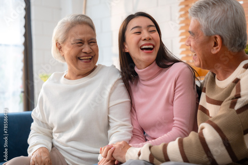 Capture the Joy of Family: Happy Grandparents Enjoying Retirement Indoors, Hugging Their Children and Grandchildren on a Couch, Sharing Smiles and Togetherness Across Generations