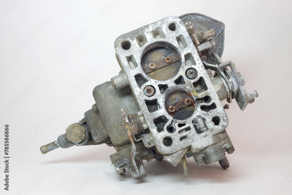 bottom side of old carburetor. Showing dual chambers with closed rusty throttle valves bottom side of old carburetor. Showing dual chambers with closed rusty throttle valves