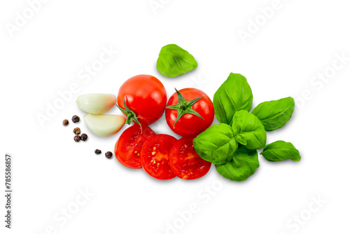 Ripe red tomatoes, sliced, basil, garlic and pepper on a white background isolate
