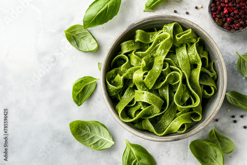 tasty traditional italian tagliatelle or linguine pasta with green pesto alla genovese or genoese in a bowl, noodles from italy with basil, top view photo