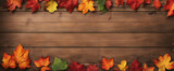 Colorful autumn leaves form a heart on an old rustic wooden table/wooden background