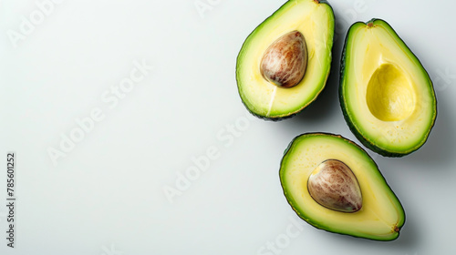 Close-up of an avocado on a gray background. Bright vegetable. Two halves of an avocado. Food concept, healthy lifestyle.