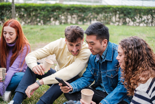 Group of friends from different origins sharing moments outdoors in a park. Concept: enjoy © Ivan