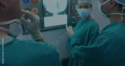 Image of data processing over diverse surgons inspecting xray