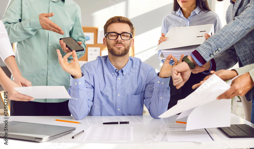 Foto Calm young man in shirt and glasses sitting at working desk with eyes closed, me