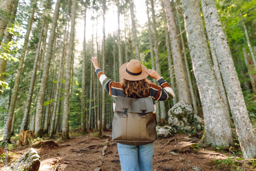 Young woman - tourist walks along a hiking trail against the backdrop of mountain scenery. Adventure, travel, tourism. Young woman - tourist walks along a hiking trail against the backdrop of mountain scenery. Adventure, travel, tourism.