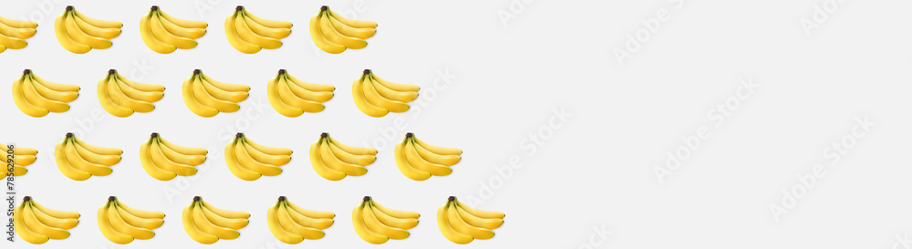 a bunch of yellow bananas on a grey texture. lots of bananas on light texture a bunch of yellow bananas on a grey texture. lots of bananas on light texture