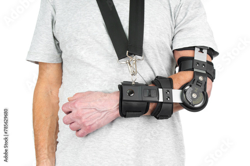 Man with a broken arm wearing in adjustable sling on white background
