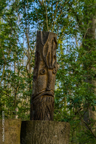 statue of a person in the forest
