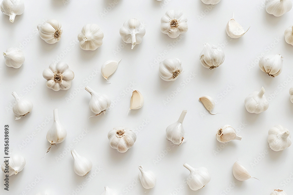 A composition of garlic on a white background. Culinary concept. Top view.
