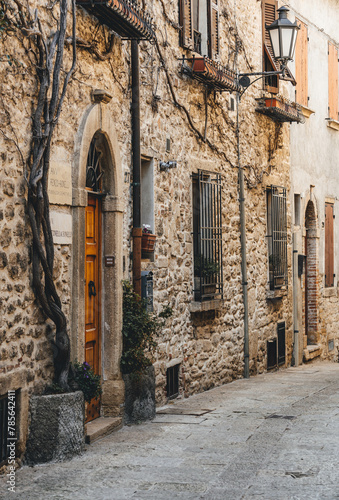 narrow street in the city of san marino with stone wall