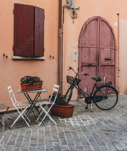 bicycle parked on the street with small table and decoration 