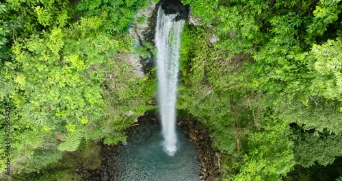 Waterfall surrounded by lush greenery in Camiguin Island. Katibawasan Falls. Philippines. photo