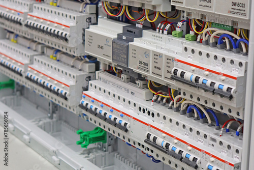 An electric switchboard with modules for protection and control of electrical loads, mounted on din rails. photo