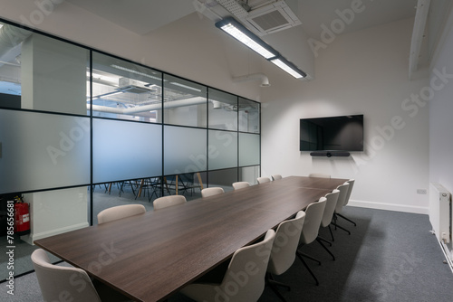 Modern conference room with glass walls and monitor photo