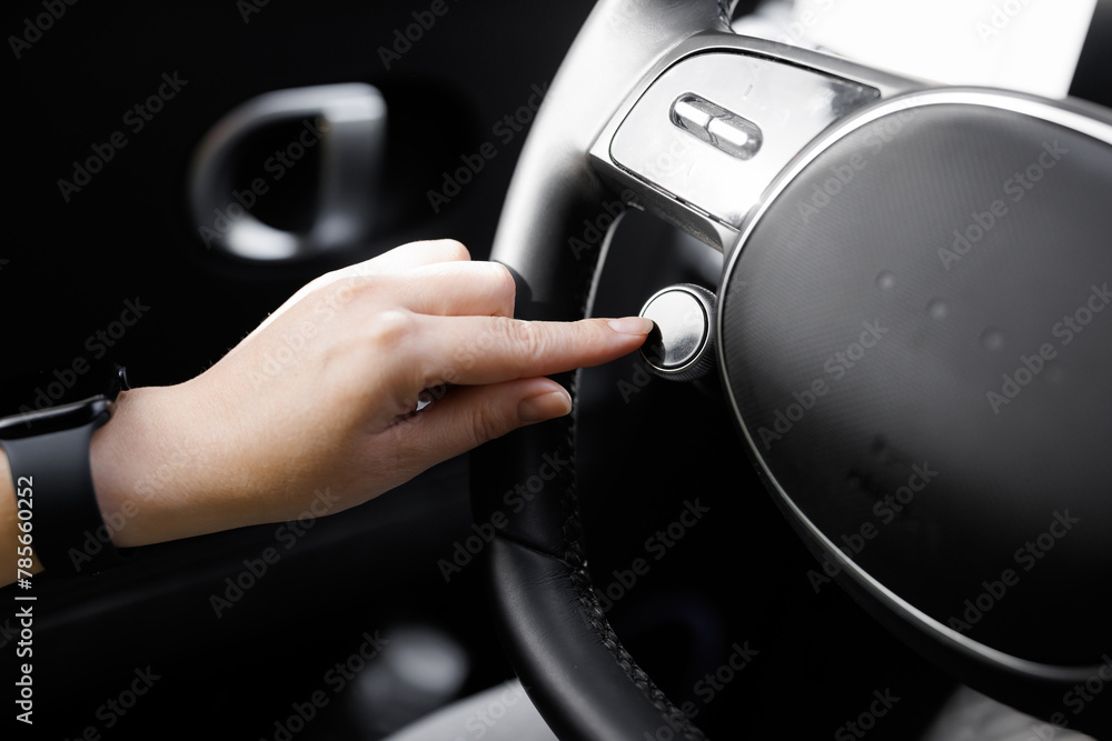 Obraz premium Driving mode button on luxury electric car. Eco mode is a relaxed and comfort sport is a fuel efficient driving mode. Smart electric vehicle concept. Sport Mode button of a car. Pressing the button
