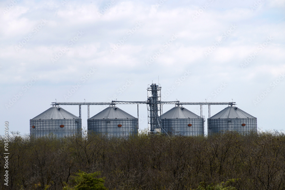 industrial grain silos for agriculture in a rural landscape industrial grain silos for agriculture in a rural landscape