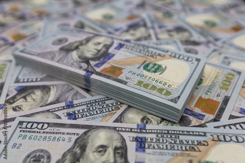 Pile of US 100 dollar banknotes on dollars background Pile of US 100 dollar banknotes on dollars background