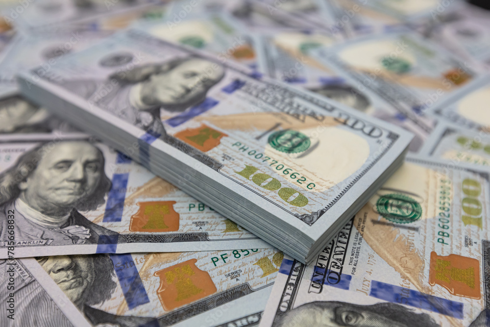 Pile of US 100 dollar banknotes on dollars background Pile of US 100 dollar banknotes on dollars background