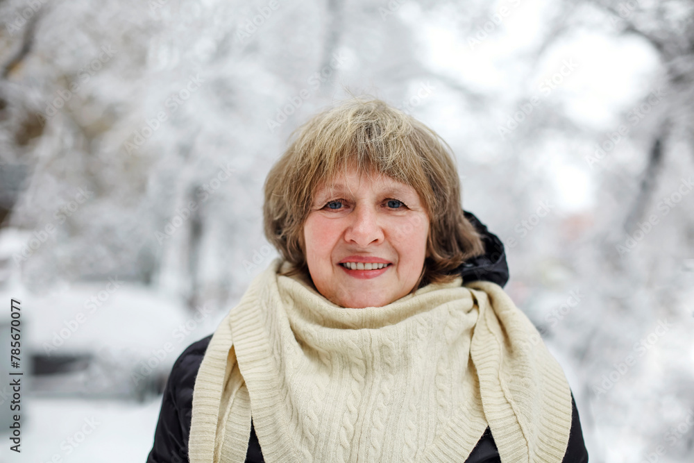 Portrait of happy senior woman enjoying frosty snowy weather outdoors Portrait of happy senior woman enjoying frosty snowy weather outdoors
