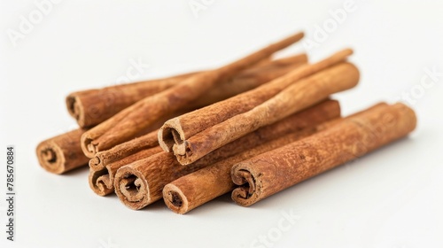 Cinnamon sticks are piledup on a white background. photo