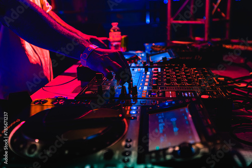 DJ hand on mixing equipment