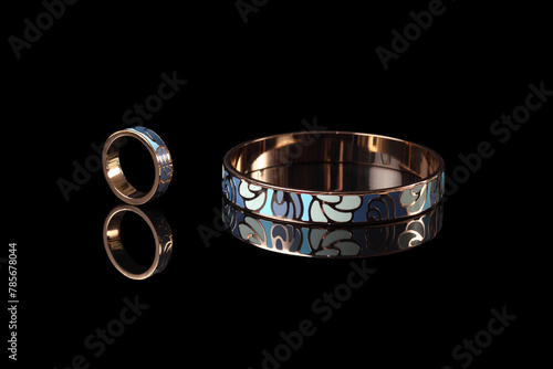 Beautiful jewelry bracelet and ring with enamel isolated on a black background. photo