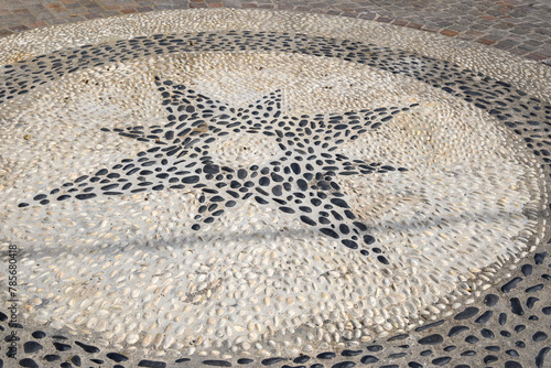 Greek pebble mosaic on the street in Nikia village. Nisyros island, Greece