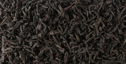 Pattern dry leaves Oolong tea, Camellia sinensis, dark green teas background and texture, top view 