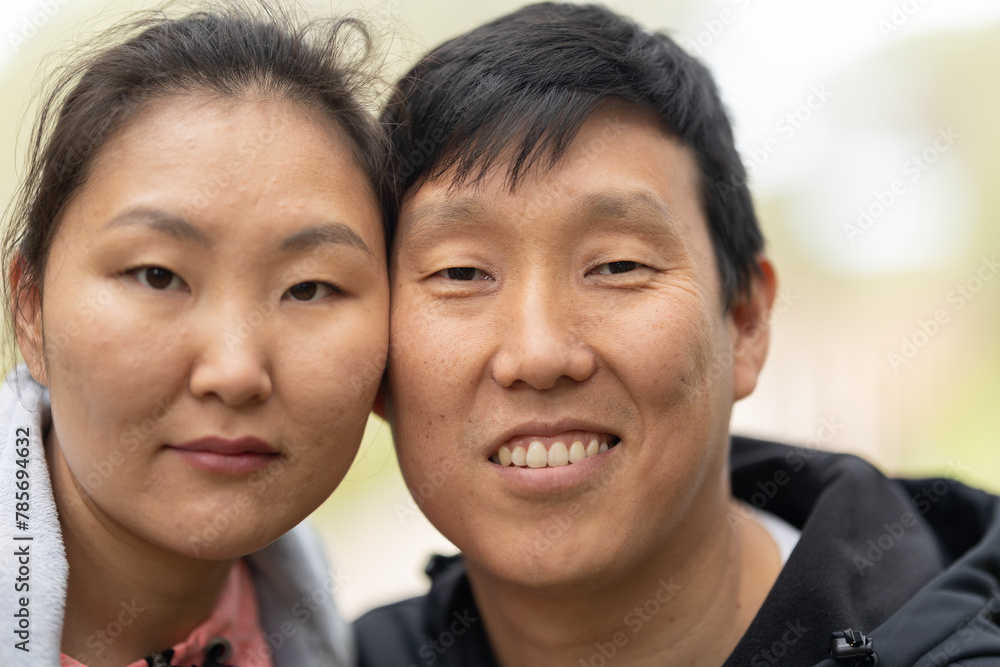 A man and woman are smiling at the camera A man and woman are smiling at the camera
