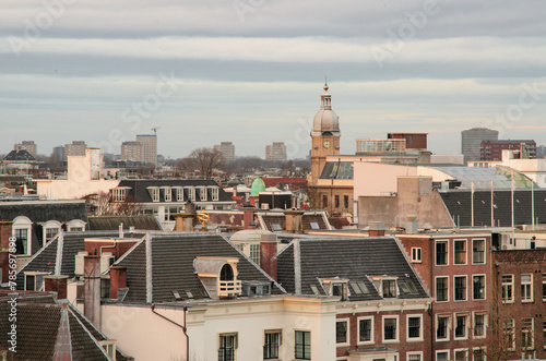 Cityscape of Amsterdam with clock tower in distance.