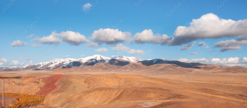 Wide panoramic mountain landscape with golden autumn steppe