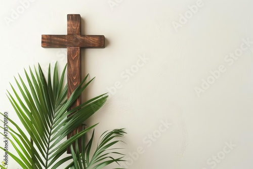 wooden cross and palm leaves on neutral background palm sunday and holy week concept copy space