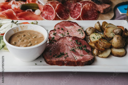 Traditional Luxembourgish dish Judd mat Gaardebounen on a plate, selective focus.