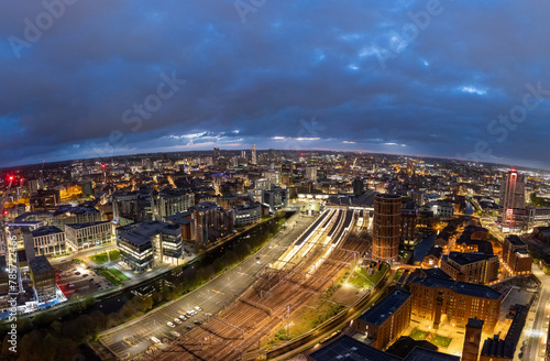 The intricate layout of Leeds, West Yorkshire's City Centre, is vividly presented in this nighttime drone capture, highlighting the building's facades and the city's infrastructure