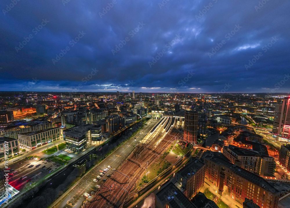 This image stunningly portrays the city of Leeds at twilight, with the streets and buildings illuminated, showcasing the bustling city centre, and pairing with the city's construction growth