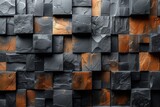 A close-up view of a textured wall with squares, showing the contrast of black stone and orange accents