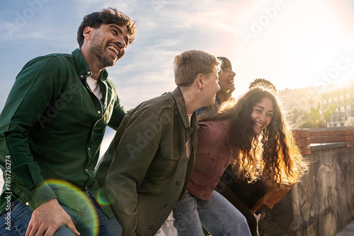 Obraz na płótnie A group of friends share contagious laughter in a sunlit setting - companionship joy and casual get-togethers
